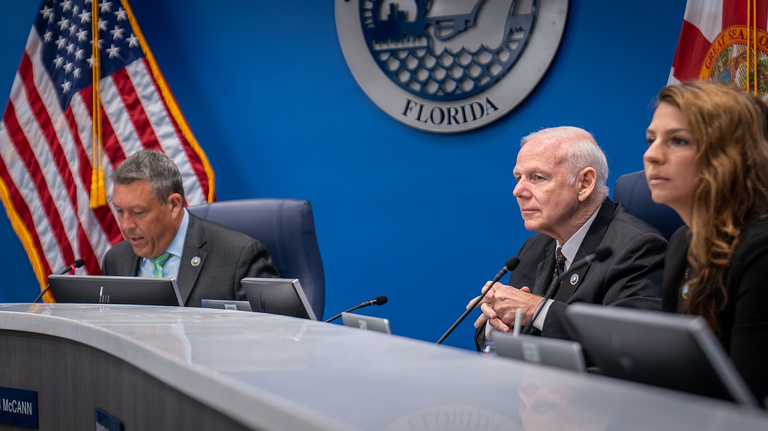Commissioners George Kruse, Bob McCann and Amanda Ballard debate the merits of a curfew for residents under the age of 17 at the Aug. 5 commission meeting.