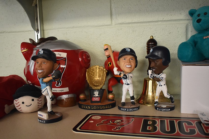 Memorabilia including bobbleheads of Tampa Bay Rays players sits on a shelf in the classroom of fith grade math teacher James Harting.