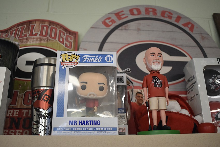 Fifth grade math teacher James Harting, a Georgia Bulldogs fan, displays gifts from his family relating to the team, including custom-made bobbleheads of himself.