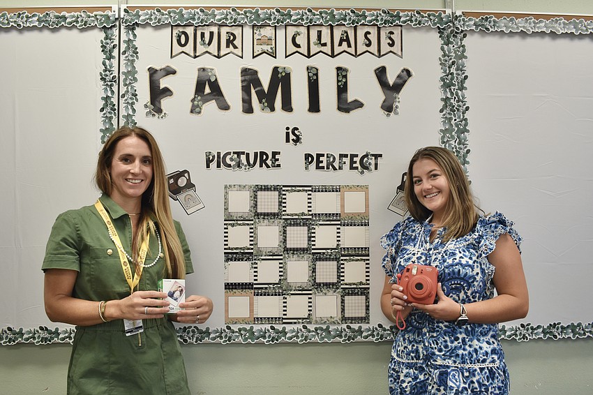 Fourth grade English language arts teacher Christine Harrington and fourth grade math and science teacher Riley Hamilton stand beside their completed display, which will feature photos of the students.