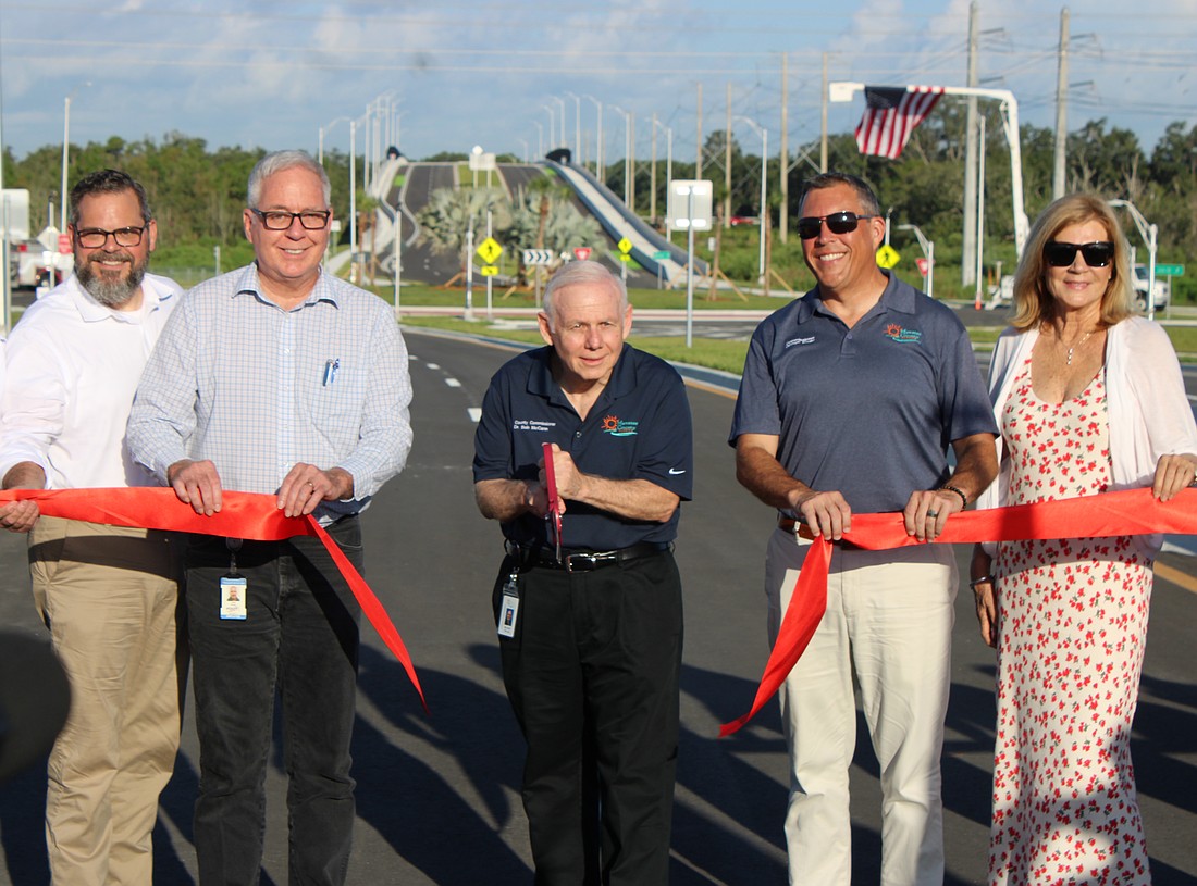 District 72 Rep. Bill Conerly, FDOT's John Kubler, Commissioner Bob McCann, Commissioner George Kruse and former Commissioner Carol Whitmore handle ribbon-cutting duties for the 44th Avenue Extension Aug. 4.