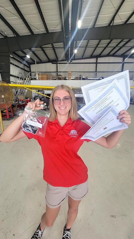Jasmine Vitkauskas holds up her certificate for completion of the program, her special commendation certificate and her certificate for completion of ground school. Courtesy photo