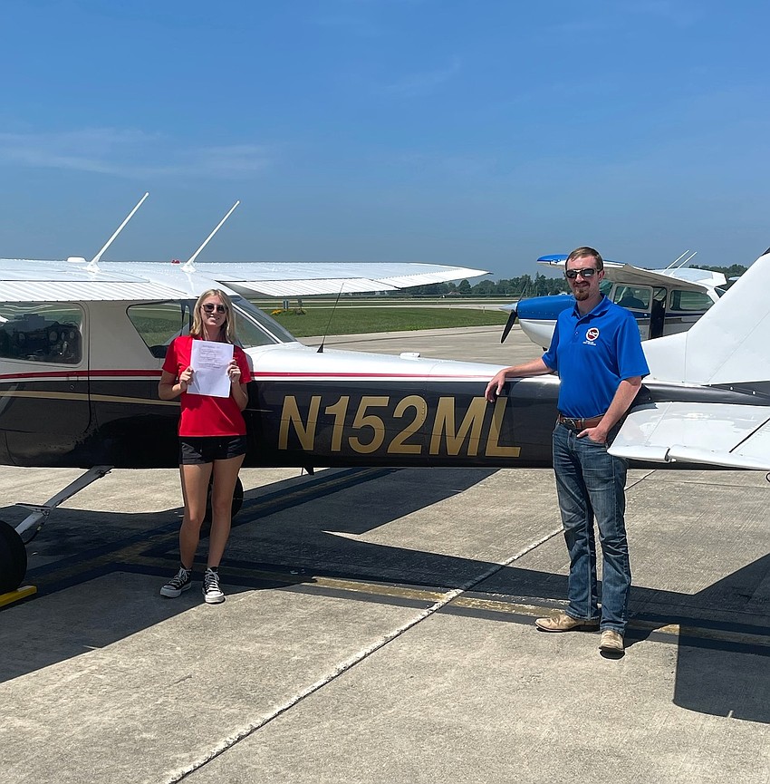 Jasmine Vitkauskas holds up her certification with flight instructor Andrew Angelo. Courtesy photo
