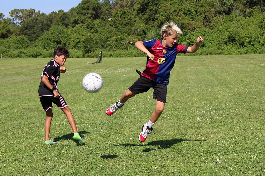 William Rasulo and Grayson Blaney do not let the heat stop them from putting their all into a game of soccer. Blaney has played soccer for four years and calls it 