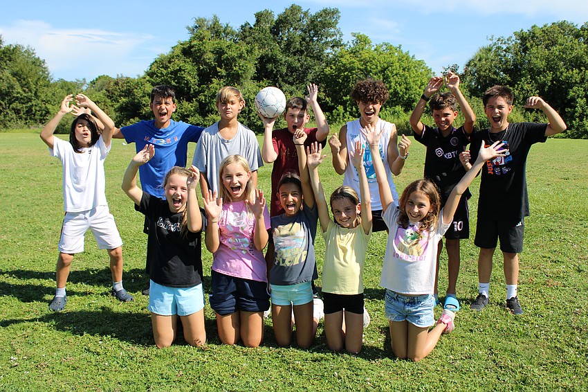 Campers between the ages of ten and eleven are eager to burn off some energy, running around and making goals, before heading to the pool to cool off.