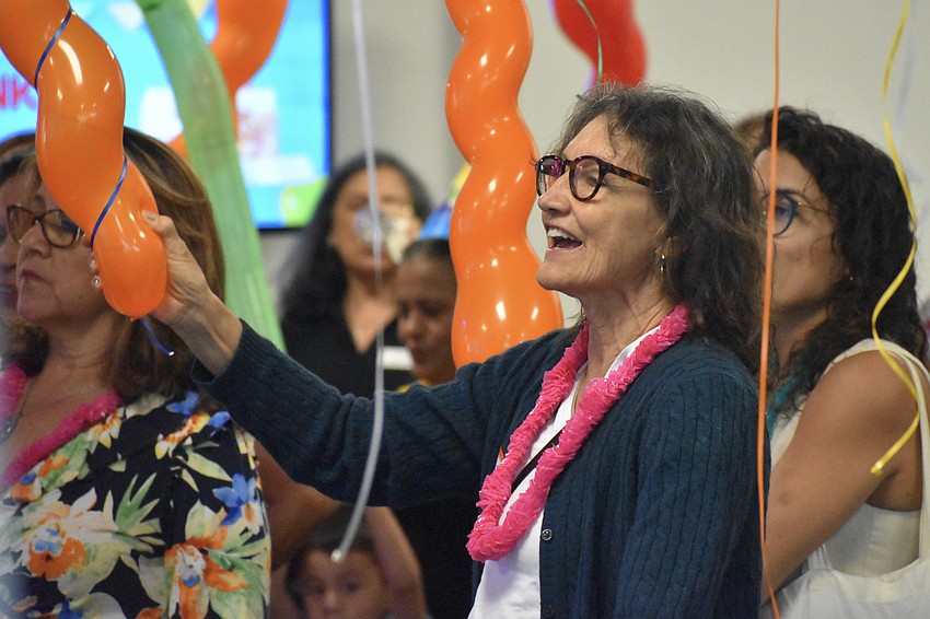 Martha Ceron joins other attendees in singing 