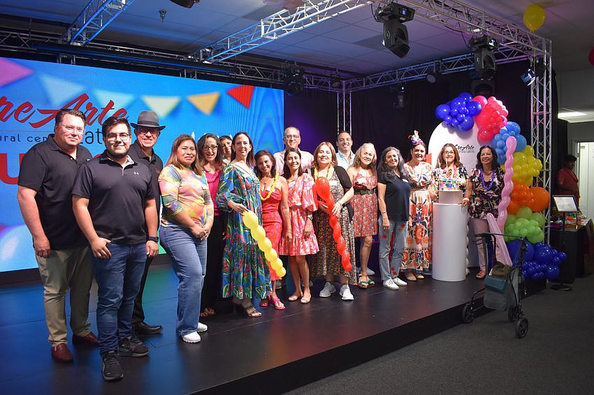 Board members and volunteers of CreArte Latino gather on stage.