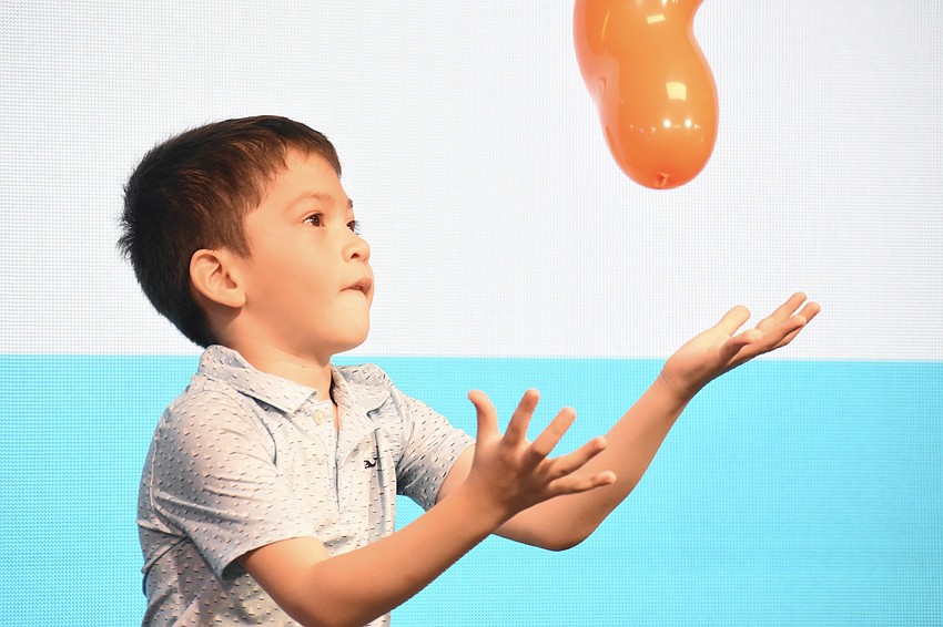 Francis Peña, 5, plays with a balloon.