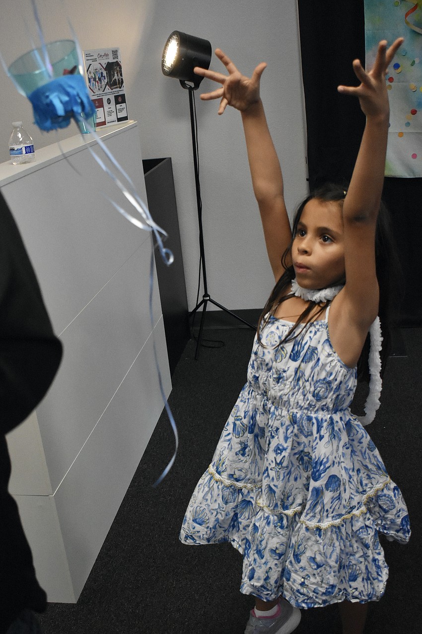 Gabriella Mendez, 7, watches as a balloon floats away.