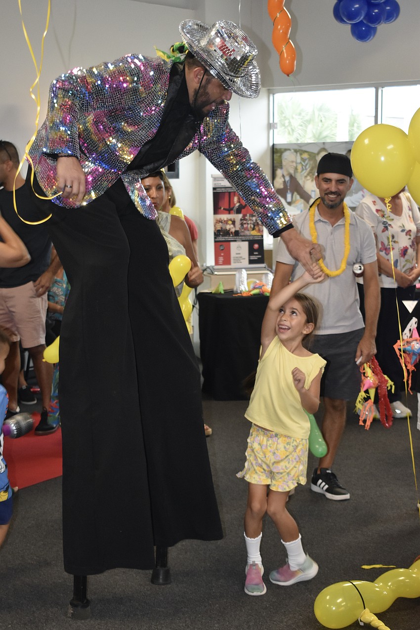 CreArte dance instructor Eddy Ossa dances with Camila Zorrilla, 6, as her father Juan Pablo Zorrilla looks on.