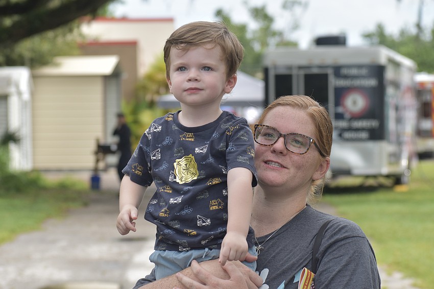 Parker Eagan, 2, and his mother Kiley Eagan watch as the helicopter comes in for a landing.