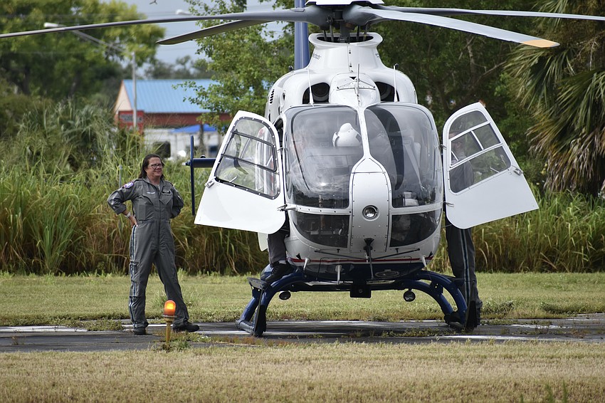 Flight Nurse Pamela Young steps out of the helicopter as it lands.