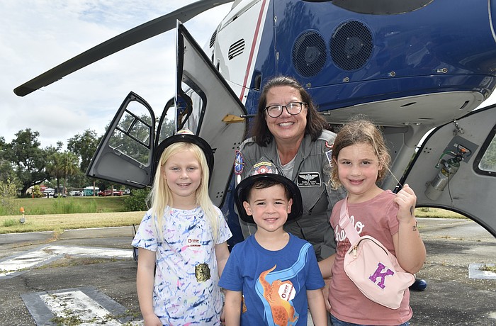 Evelyn Lucas, 5, and her friends Kevin McGuckin, 3, and his sister Kinsley McGuckin, 5 (front row) pose with Flight Nurse Pamela Young.