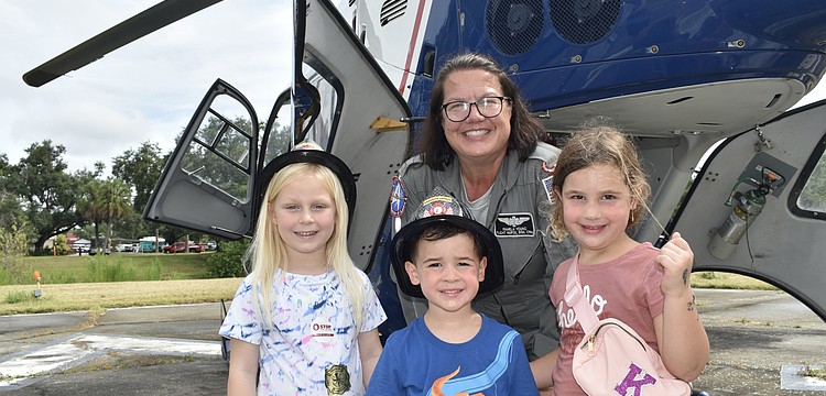 Evelyn Lucas, 5, and her friends Kevin McGuckin, 3, and his sister Kinsley McGuckin, 5 (front row) pose with Flight Nurse Pamela Young.
