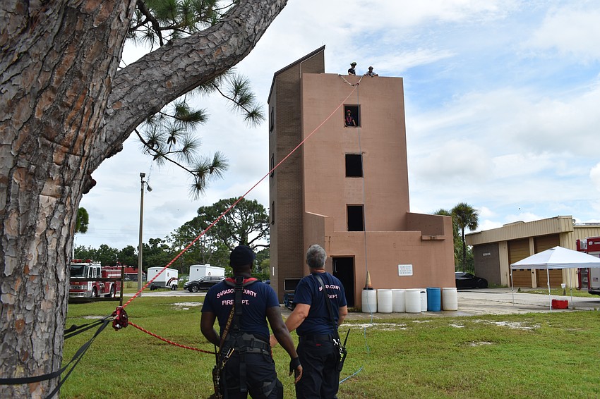Firefighters set up a rapelling demonstration.