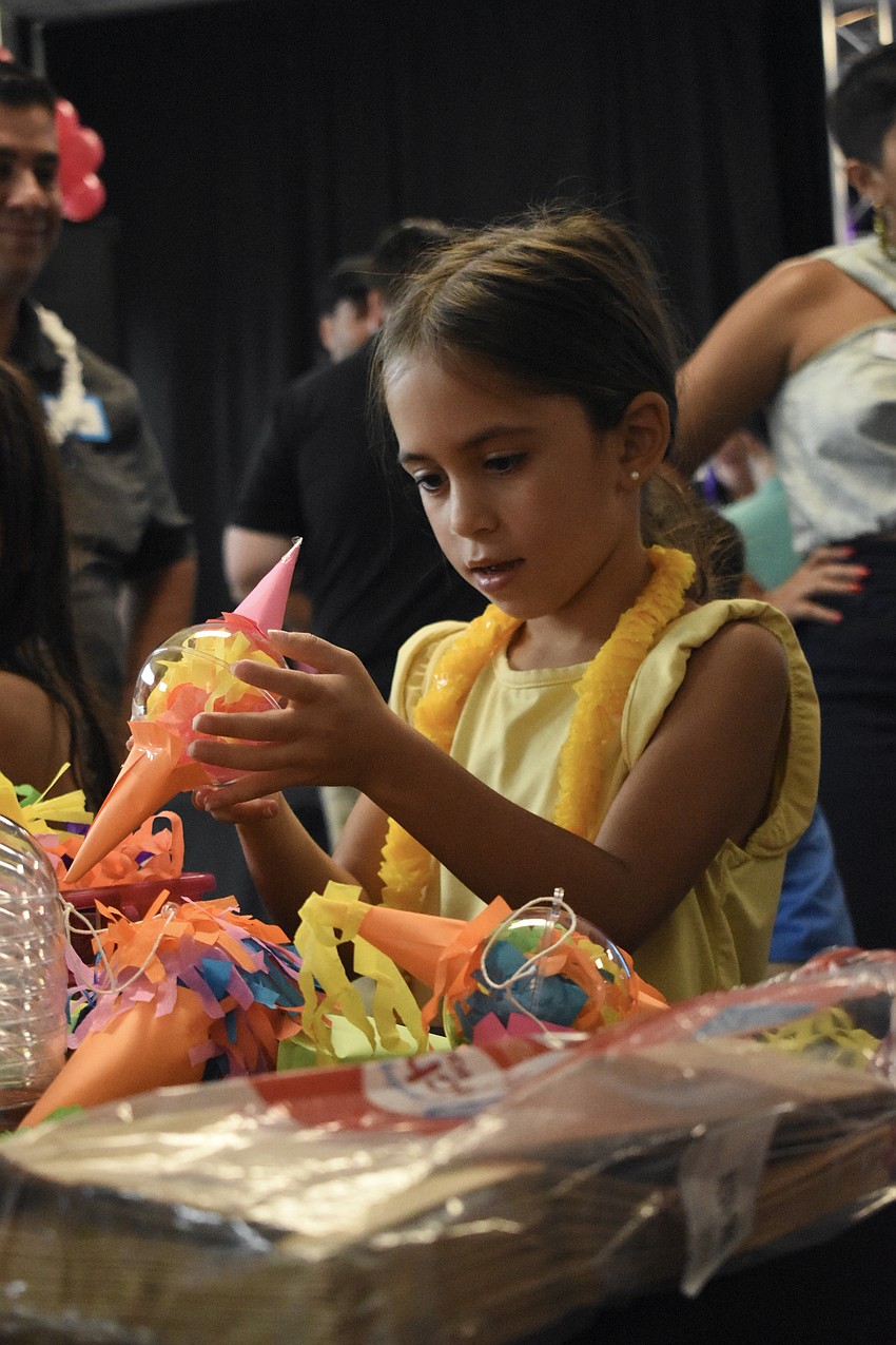 Camila Zorrilla, 6, pieces together a craft item.