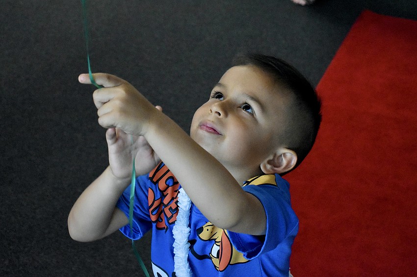Daniel Mendez, 4, plays with one of the balloons found on the ceiling of the room.
