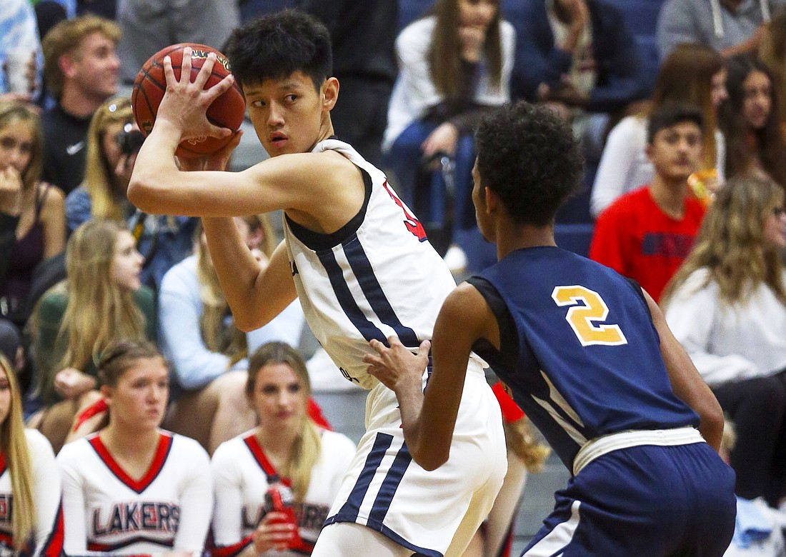 Windermere Prep basketball player Fanbo Zeng held the ball and surveyed the court.