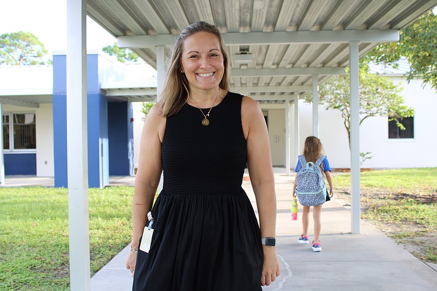 Alta Vista Principal Meredith McArthur gets students started on the right foot on the first day of school Monday morning.