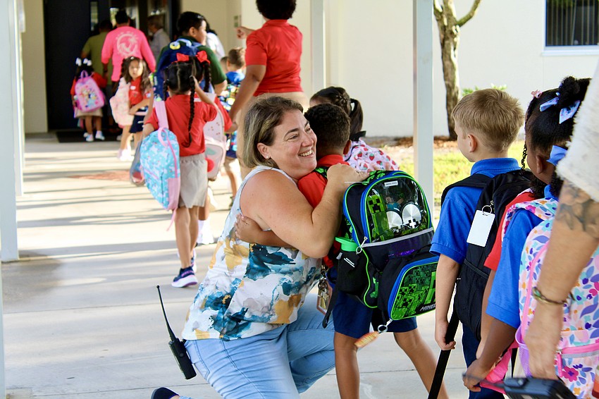 Laura Busenburg, math science coach at Alta Vista Elementary School, greets returning students at the first day of school on Monday.