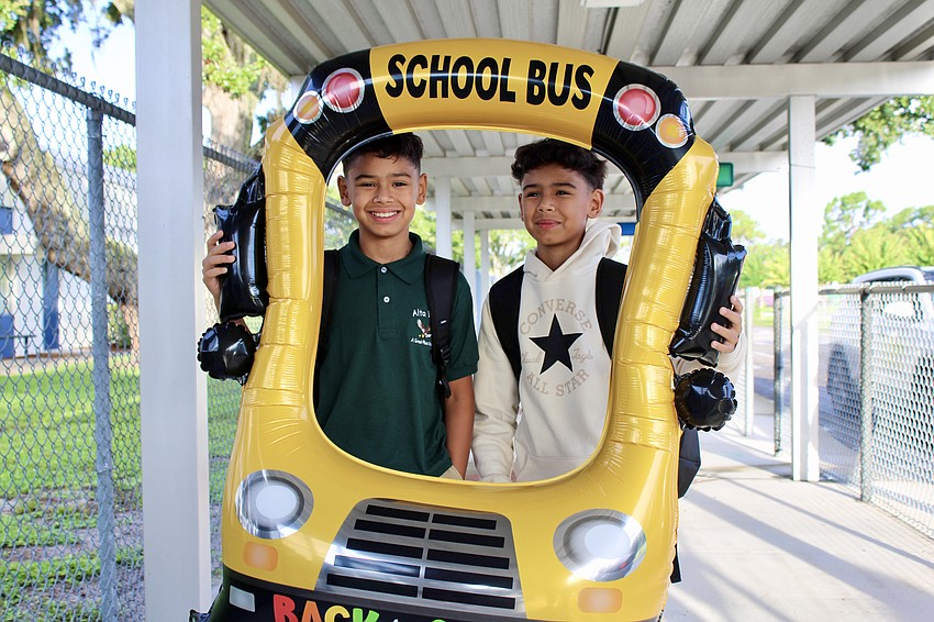 Jesus and Juan Moncada get a warm greeting from staff at Alta Vista Elementary School on the first day of the new school year.