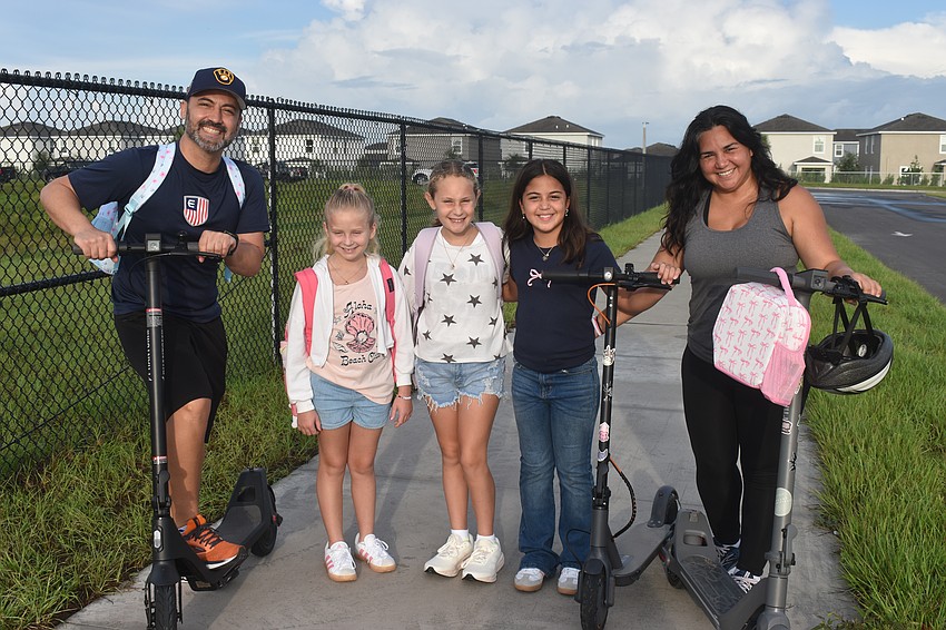 Ricardo Vasquez, Layla Boron, Colette Kropfl, Kiali Vasquez and Monica Rodriguez appreciate the beauty of the new Lake Manatee school and how family oriented the neighborhood is. Boron, Kropfl and Vasquez are all starting fourth grade.