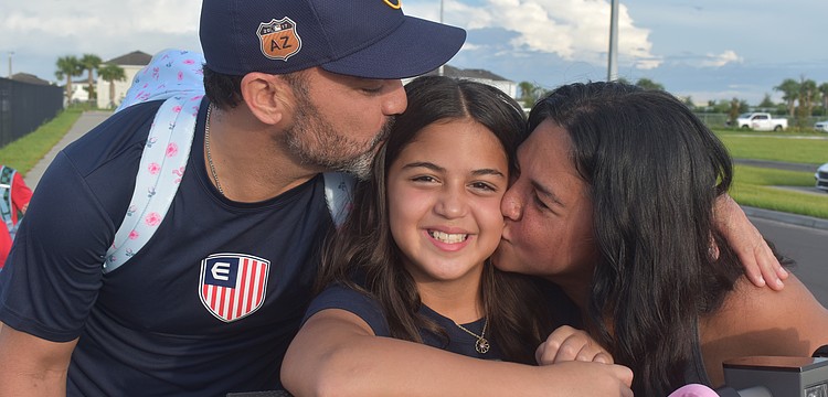 Ricardo Vasquez and Monica Rodriguez wish their daughter Kiali Vasquez good luck on her first day with a kiss. Kiali is determined to get straight A's.