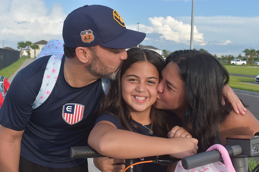 Ricardo Vasquez and Monica Rodriguez wish their daughter Kiali Vasquez good luck on her first day with a kiss. Kiali is determined to get straight A's.