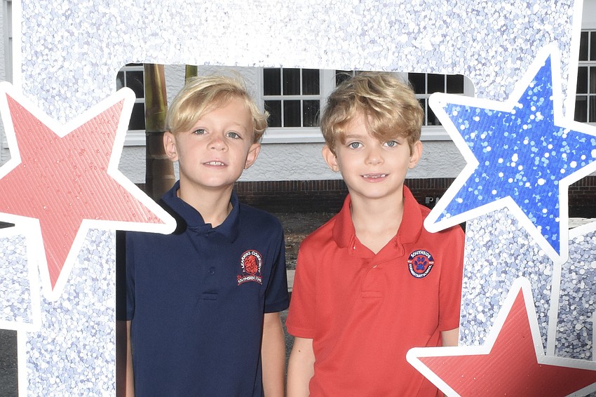 Second grader Zack Taylor and third grader Noah Winter, his neighbor, pose inside the 