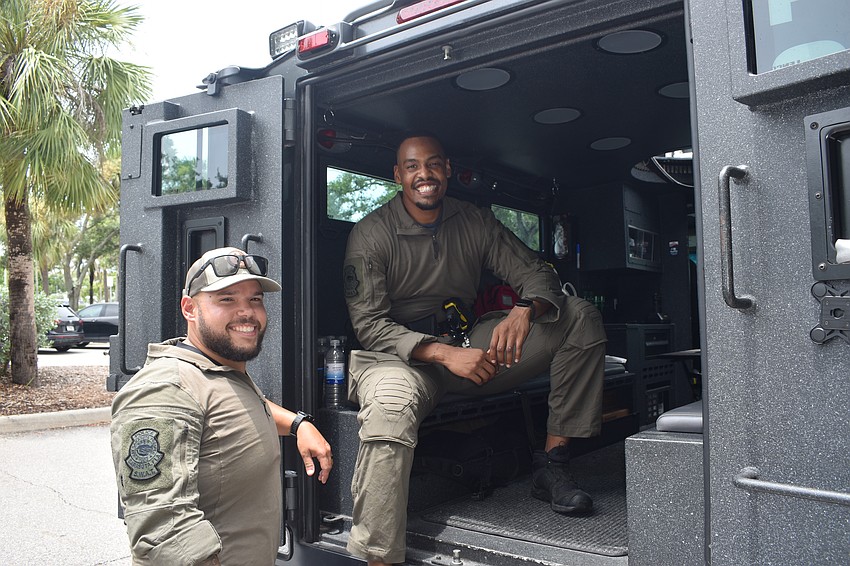 Officers including Will Garcia and Dan Stevens showcased the Sarasota Police Department's SWAT vehicle, one of the emergency services vehicles on display.