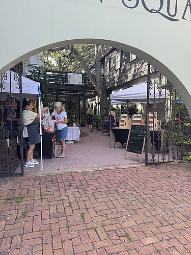 People peruse the new farmer's market at Fountain Square Village, to be held weekly on Sundays. Courtesy photo