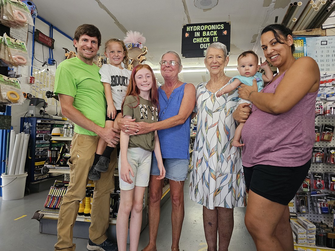 Four generations of the Russell family, the owners of Hammock Hardware with long-time employee Nina Caton. From left to right: Alex Russell holding Jolina Caton, 4; Tinsley Russell, 10; current owner Robyn Jennings; founder Margaret Russell; employee Nina Caton with her 5-month-old daughter Naomi. Photo by Sierra Williams