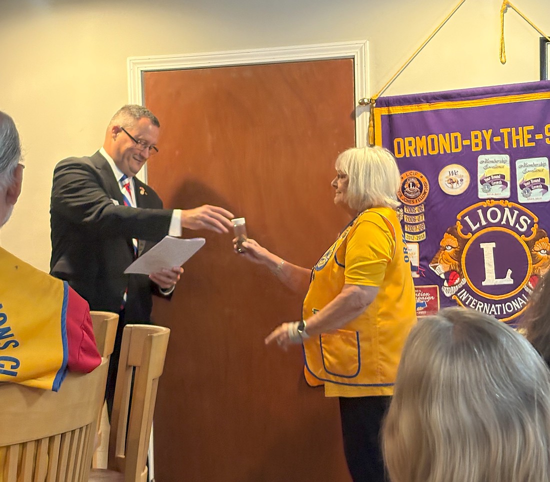Volusia County Tax Collector Will Roberts installs Lion Aleta Dick as president for 2025-2026 Lions Year. Courtesy photo