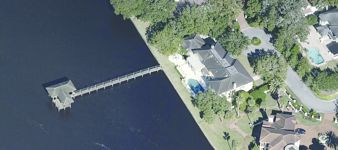 Riverfront two-story home features four bedrooms, five full and one half-bathrooms, bonus room, office, porches, balcony, pool and dock. It is near the Epping Forrest Yacht Club.