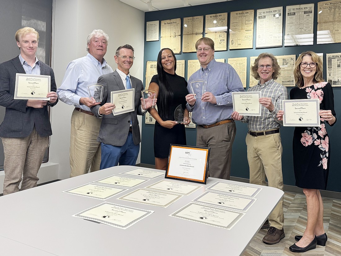 Jacksonville Daily Record staff members show off their awards. From left, Joe Lister, Dan Macdonald, Ric Anderson, Codi Gildberg, Monty Zickuhr, David Crumpler and Karen Brune Mathis. Editorial team members not pictured are Mark Basch, Max Marbut, Scott Sailer and J. Brooks Terry.