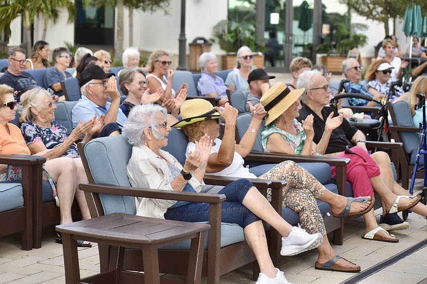 The crowd claps along with the band.