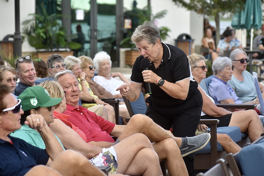 Conductor Lynn Cleary heads into the crowd to find some backup singers.