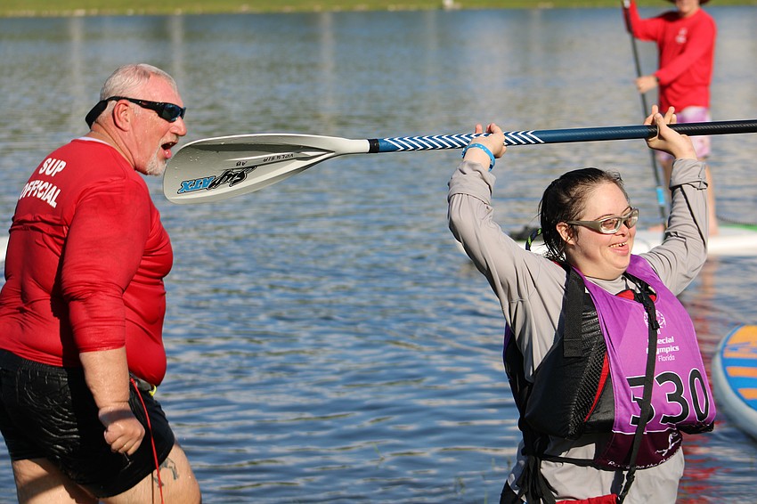 Pinellas County's Tim Scholz cheers on Volusia Count's Allacyn Beebe, who didn't let a dip in the water stop her from completing her 200 meter race.