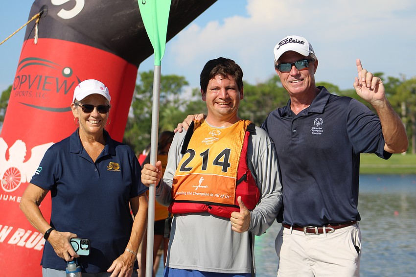 Manatee County's Diane Rabbu, son Timothy Rabbu and coach Mark Flanagan celebrate Timothy's completion of his 3200 meter race. Timothy plays various sports including soccer, tennis and basketball.