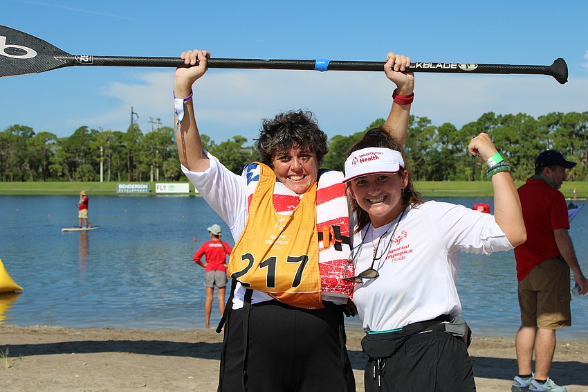 Monroe County's Jennifer Averette completes her 3200 meter race and is congratulated by her coach Ellyn Badry.