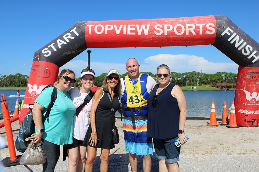 St Lucie County's Joshua Stemm has a team ready to congratulate his completion of the 800 meter race: Renee Ximanies, Lindsay Ximanies, coach Tree Capozzole and Shannon Rochester.