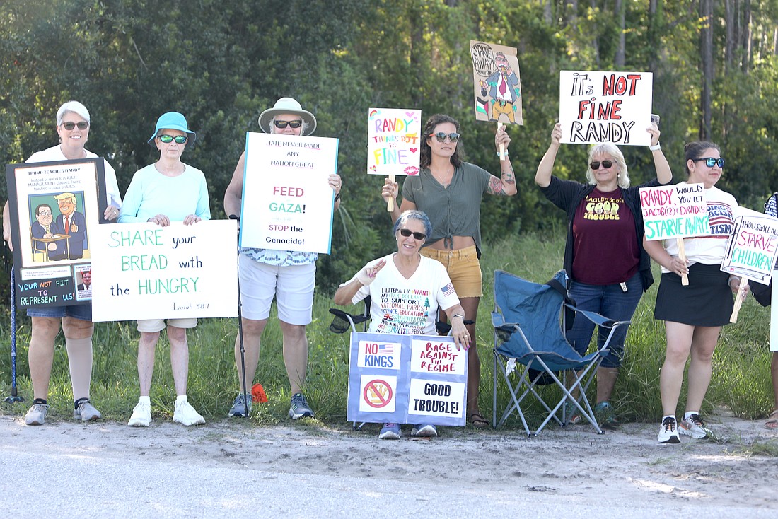 Protesters at the corner of Utility Drive and Old Kings Road in Palm Coast ahead of Rep. Randy Fine's appearance at Palm Coast's Wastewater Treatment Plant 1 on the morning of Aug. 13. Photo by Brent Woronoff
