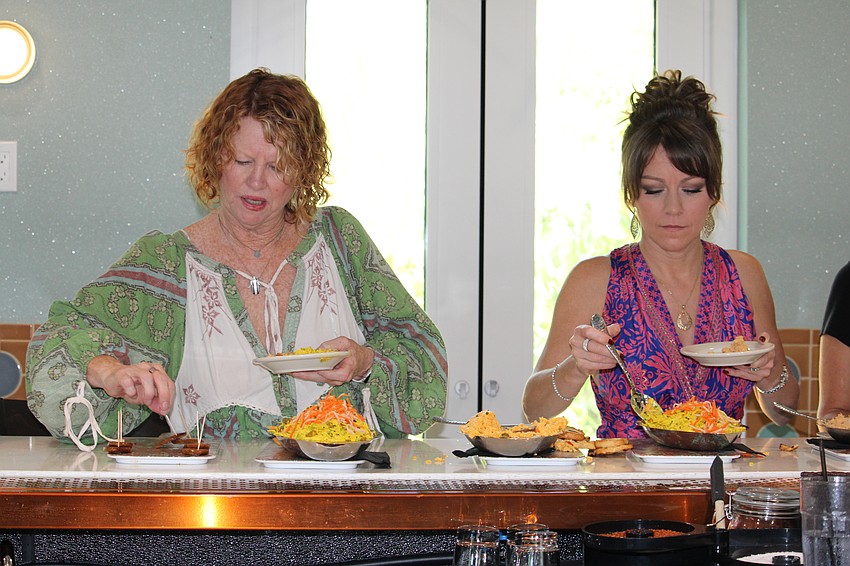 Julie Wilson and Jen Braden from Skyrun Sarasota Vacation Rentals dish up some of the cold appetizers at Lo' Key Island Grille.