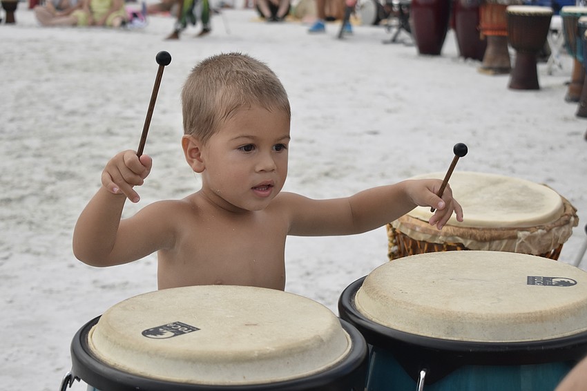 Joshua Barrera, 2, tries out a set of drums, during his first time at the drum circle. 