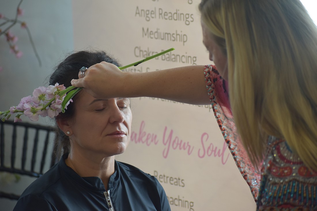 Ana Salmon receives a demonstration from Elyse Falzone, an intuitive energy healer and spiritual mentor.