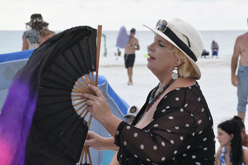 Morgan Crane waves a fan as she dances in the circle.