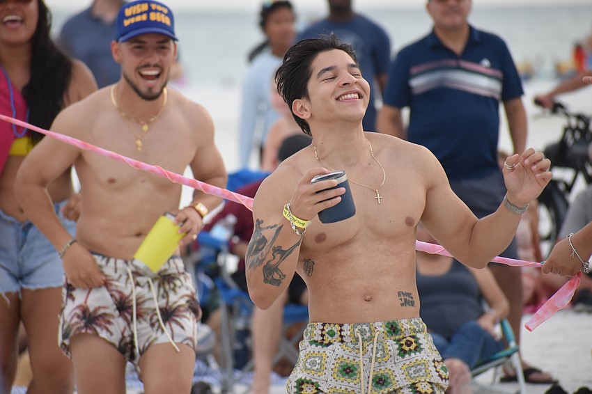 Damian Perez and his brother Luigi Garcia do the limbo.