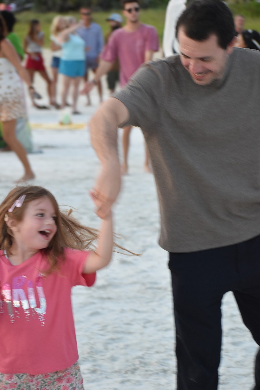 Isabelle Piccini, 5, twirls in a circle with her father Angelo Piccini.