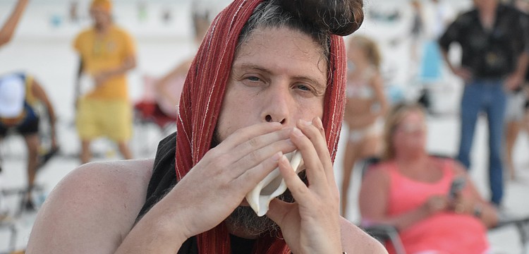 Jose Angel Figueroa Jr. makes music in the circle.