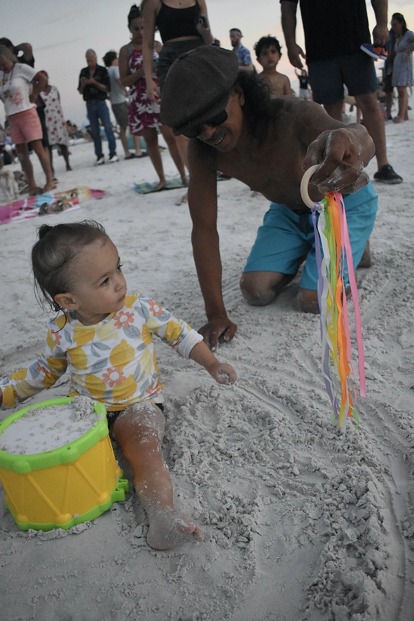 Myla VanReenen, 2, sits in a circle drawn by her grandfather Rodney VanReenen.